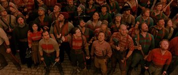 Movie still from “Gangs of New York” (2002), directed by Martin Scorsese – A group of men in red and brown shirts holding guns; Wide shot, High angle