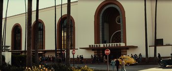 Movie still from “Gangster Squad” (2013), directed by Ruben Fleischer – People are walking in front of the union station in los angeles; Extreme Wide shot, Low angle