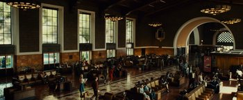 Movie still from “Gangster Squad” (2013), directed by Ruben Fleischer – People are sitting and standing in a large room; Extreme Wide shot, High angle