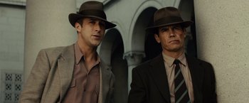Movie still from “Gangster Squad” (2013), directed by Ruben Fleischer – A couple of men wearing hats and suits; Medium shot, Low angle