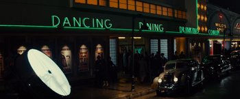 Movie still from “Gangster Squad” (2013), directed by Ruben Fleischer – A group of people standing in front of a building at night; Extreme Wide shot, High angle