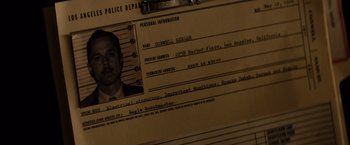 Movie still from “Gangster Squad” (2013), directed by Ruben Fleischer – An old police photo of a man with a mustache; Extreme Close Up shot, High angle