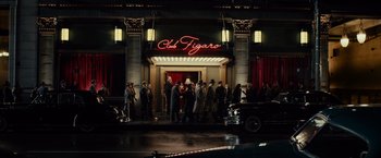 Movie still from “Gangster Squad” (2013), directed by Ruben Fleischer – A group of people standing in front of a building at night; Extreme Wide shot, Low angle