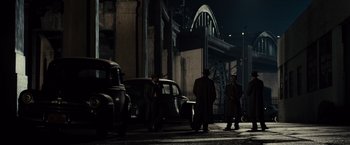 Movie still from “Gangster Squad” (2013), directed by Ruben Fleischer – A group of men standing next to each other on a street; Extreme Wide shot, High angle