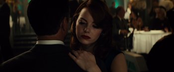 Movie still from “Gangster Squad” (2013), directed by Ruben Fleischer – A man and a woman in a dark room; Close Up shot, Over the shoulder angle