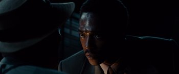 Movie still from “Gangster Squad” (2013), directed by Ruben Fleischer – A person wearing a suit and tie; Close Up shot, Over the shoulder angle