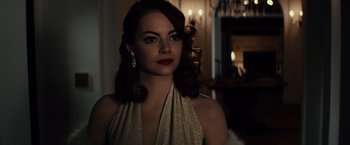 Movie still from “Gangster Squad” (2013), directed by Ruben Fleischer – A woman in a gold dress with long brown hair; Close Up shot, Over the shoulder angle
