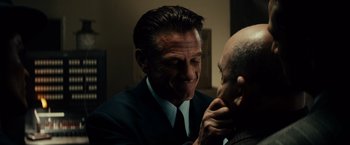 Movie still from “Gangster Squad” (2013), directed by Ruben Fleischer – A person wearing a suit and tie; Close Up shot, Over the shoulder angle