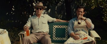 Movie still from “Gangster Squad” (2013), directed by Ruben Fleischer – A man and a woman sitting on a bench; Medium shot, Low angle