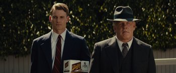 Movie still from “Gangster Squad” (2013), directed by Ruben Fleischer – A man in a suit and tie next to another man in a suit and tie; Medium shot, Low angle