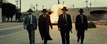 Movie still from “Gangster Squad” (2013), directed by Ruben Fleischer – A group of men walking down a street with guns in their hands; Wide shot, Low angle