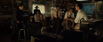 Movie still from “Gangster Squad” (2013), directed by Ruben Fleischer – A group of men sitting in a room next to each other; Wide shot, Low angle