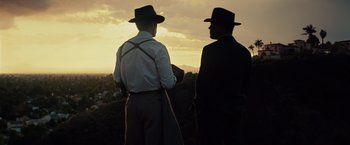 Movie still from “Gangster Squad” (2013), directed by Ruben Fleischer – A couple of men standing on top of a hill; Wide shot, Low angle