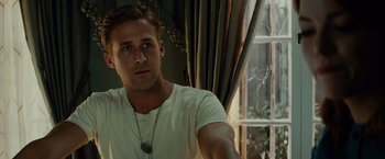 Movie still from “Gangster Squad” (2013), directed by Ruben Fleischer – A person wearing a white t - shirt; Close Up shot, Over the shoulder angle