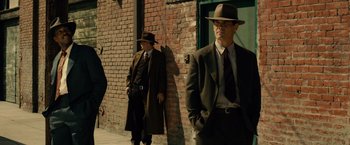 Movie still from “Gangster Squad” (2013), directed by Ruben Fleischer – A group of men standing next to each other on a sidewalk; Wide shot, Low angle
