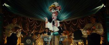 Movie still from “Gangster Squad” (2013), directed by Ruben Fleischer – A woman in a costume is singing into a microphone; Medium shot, Low angle