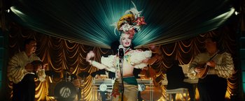 Movie still from “Gangster Squad” (2013), directed by Ruben Fleischer – A woman in a costume is singing into a microphone; Medium shot, Over the shoulder angle