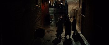 Movie still from “Gangster Squad” (2013), directed by Ruben Fleischer – A group of people standing in a dark alleyway at night; Extreme Wide shot, High angle