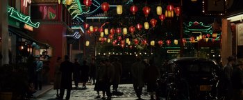 Movie still from “Gangster Squad” (2013), directed by Ruben Fleischer – A group of people standing under red and yellow lights; Extreme Wide shot, High angle