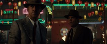 Movie still from “Gangster Squad” (2013), directed by Ruben Fleischer – A couple of men standing next to each other in a room; Medium shot, Low angle
