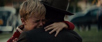Movie still from “Gangster Squad” (2013), directed by Ruben Fleischer – A child crying while hugging an older person; Close Up shot, Over the shoulder angle