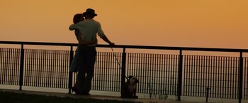 Movie still from “Gangster Squad” (2013), directed by Ruben Fleischer – A man and a woman standing next to each other; Wide shot, Low angle