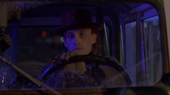 Movie still from “Gas Food Lodging” (1992), directed by Allison Anders – A man sitting in the drivers seat of a car; Close Up shot, Low angle