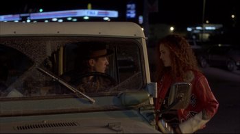 Movie still from “Gas Food Lodging” (1992), directed by Allison Anders – A man and a woman sitting in the drivers seat of a truck; Medium shot, Over the shoulder angle