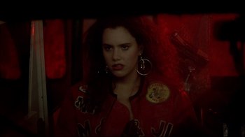 Movie still from “Gas Food Lodging” (1992), directed by Allison Anders – A woman in a red jacket and a pair of silver earrings; Close Up shot, Over the shoulder angle