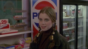 Movie still from “Gas Food Lodging” (1992), directed by Allison Anders – A young woman with long brown hair wearing a brown jacket; Close Up shot, Over the shoulder angle