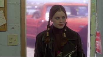 Movie still from “Gas Food Lodging” (1992), directed by Allison Anders – A young woman with long braids wearing a leather jacket; Close Up shot, Over the shoulder angle