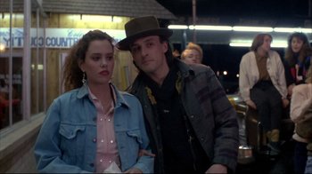Movie still from “Gas Food Lodging” (1992), directed by Allison Anders – A man and a woman standing next to each other; Medium shot, Over the shoulder angle