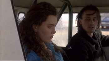 Movie still from “Gas Food Lodging” (1992), directed by Allison Anders – A woman sitting in a car with her eyes wide open; Close Up shot, Over the shoulder angle