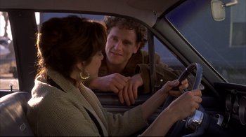 Movie still from “Gas Food Lodging” (1992), directed by Allison Anders – A man and a woman in a car looking at a cell phone; Close Up shot, Over the shoulder angle