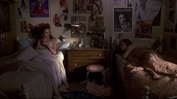Movie still from “Gas Food Lodging” (1992), directed by Allison Anders – Two women sitting in a room with a dresser and a lamp; Wide shot, High angle