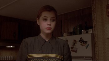 Movie still from “Gas Food Lodging” (1992), directed by Allison Anders – A woman standing in front of a refrigerator in a kitchen; Close Up shot, Over the shoulder angle