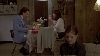Movie still from “Gas Food Lodging” (1992), directed by Allison Anders – A man and a woman sitting at a dinner table; Medium shot, Over the shoulder angle