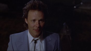 Movie still from “Gas Food Lodging” (1992), directed by Allison Anders – A person wearing a suit and tie; Close Up shot, Low angle