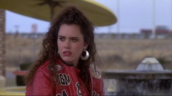 Movie still from “Gas Food Lodging” (1992), directed by Allison Anders – A woman in a red leather jacket and a black and white earring; Close Up shot, Over the shoulder angle