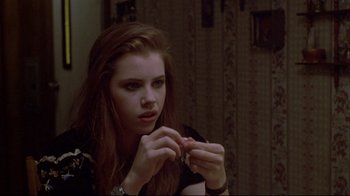 Movie still from “Gas Food Lodging” (1992), directed by Allison Anders – A woman looking at a piece of paper in her hands; Close Up shot, Over the shoulder angle