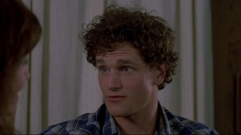 Movie still from “Gas Food Lodging” (1992), directed by Allison Anders – A young man with blue eyes and curly brown hair; Close Up shot, High angle