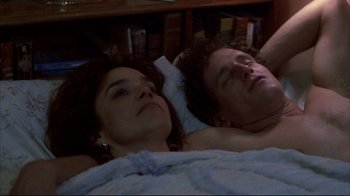 Movie still from “Gas Food Lodging” (1992), directed by Allison Anders – A man and a woman laying in a bed together; Close Up shot, High angle