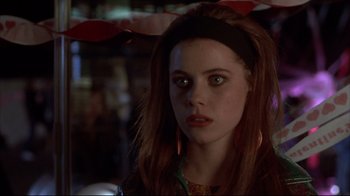 Movie still from “Gas Food Lodging” (1992), directed by Allison Anders – A woman with long red hair is looking at the camera; Close Up shot, Over the shoulder angle