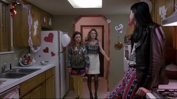 Movie still from “Gas Food Lodging” (1992), directed by Allison Anders – Two women and a man in a kitchen; Wide shot, Low angle