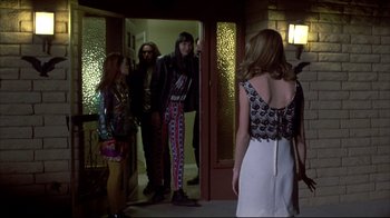 Movie still from “Gas Food Lodging” (1992), directed by Allison Anders – A group of people standing in front of a door; Wide shot, Over the shoulder angle