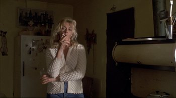 Movie still from “Gas Food Lodging” (1992), directed by Allison Anders – A woman is smoking a cigarette in a room; Medium shot, Low angle