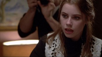 Movie still from “Gas Food Lodging” (1992), directed by Allison Anders – A young woman is looking at the camera; Close Up shot, Over the shoulder angle