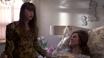 Movie still from “Gas Food Lodging” (1992), directed by Allison Anders – Two young women are talking in a room; Medium shot, High angle