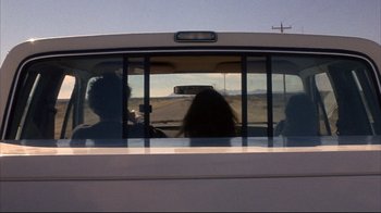 Movie still from “Gas Food Lodging” (1992), directed by Allison Anders – A group of people sitting in the back of a bus; Wide shot, Low angle