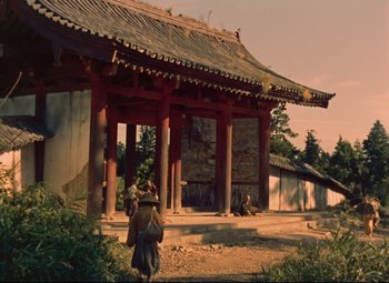 An asian building with a person walking in front of it
